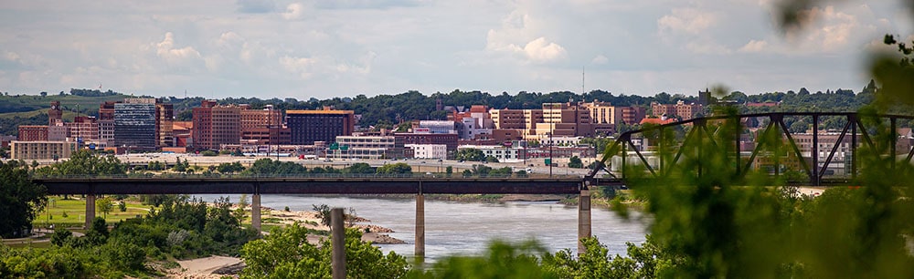 View of downtown Sioux City with the Missouri River and bridge in foreground.