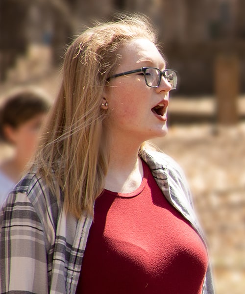Student singing outdoors